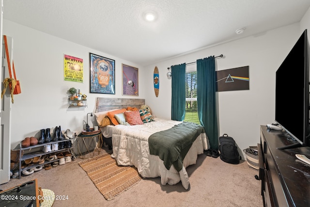 carpeted bedroom featuring a textured ceiling