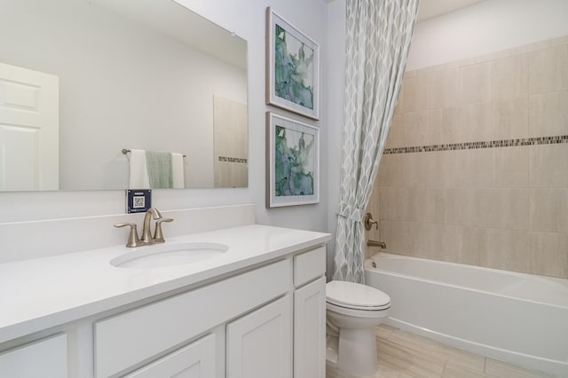 full bathroom with shower / tub combo with curtain, vanity, and toilet