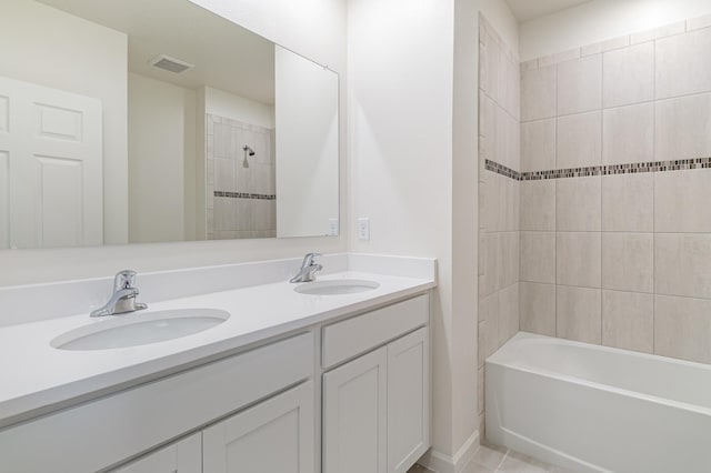 bathroom with vanity, tile patterned floors, and tiled shower / bath