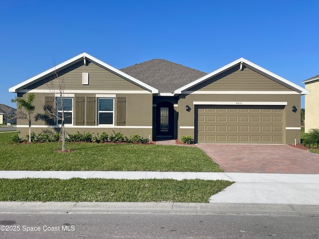 view of front of house featuring a garage and a front lawn