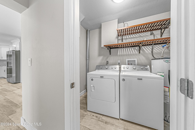 laundry room with washing machine and dryer and electric water heater