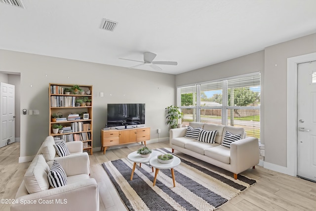 living room with light hardwood / wood-style flooring and ceiling fan