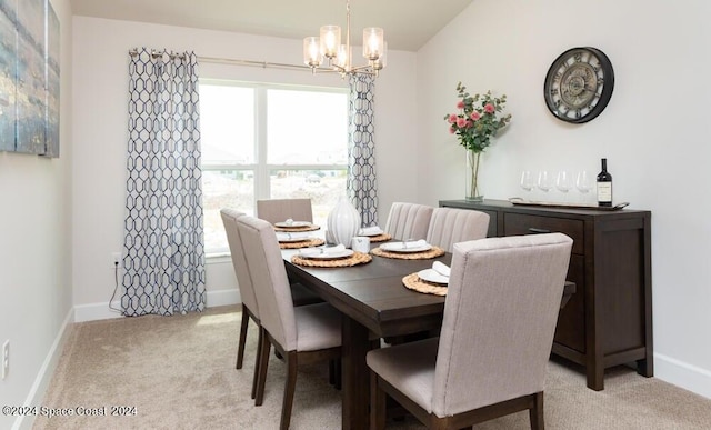 carpeted dining area featuring vaulted ceiling and an inviting chandelier