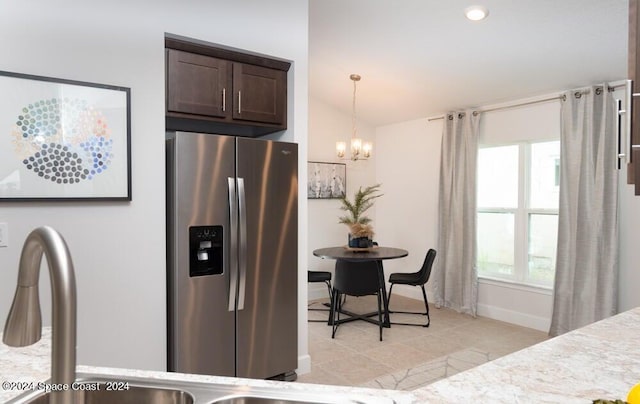 kitchen featuring lofted ceiling, dark brown cabinets, decorative light fixtures, stainless steel refrigerator with ice dispenser, and an inviting chandelier