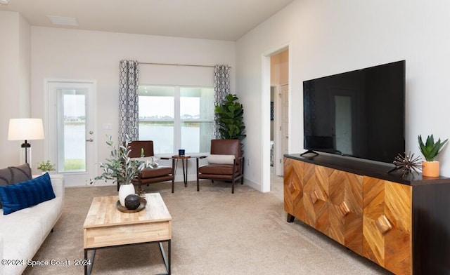 living room featuring a healthy amount of sunlight and carpet