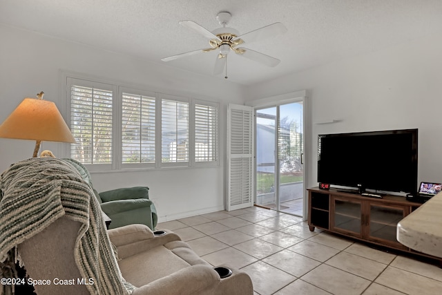 living room with light tile patterned flooring, plenty of natural light, and ceiling fan