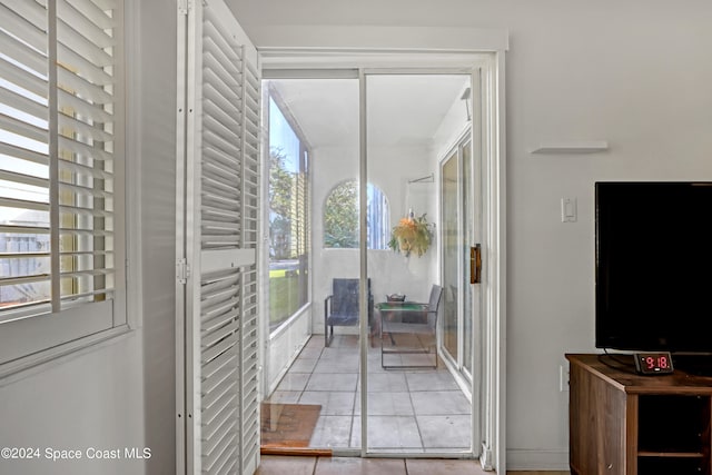 doorway to outside featuring light tile patterned flooring