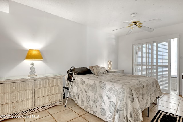 tiled bedroom featuring ceiling fan