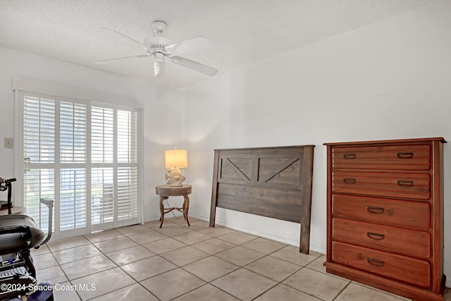 interior space featuring ceiling fan, multiple windows, and light tile patterned floors