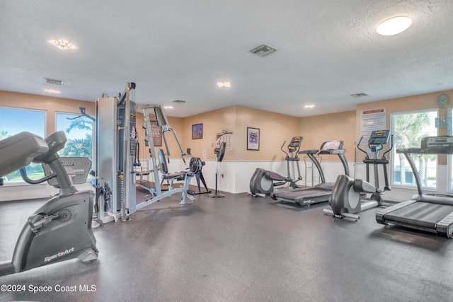 workout area featuring a textured ceiling