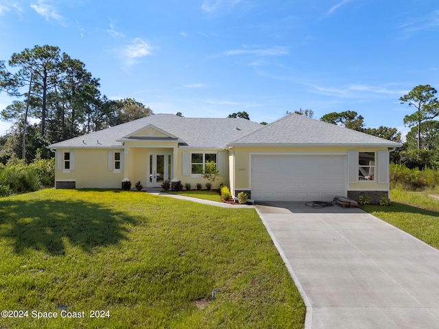 ranch-style house featuring a front lawn and a garage