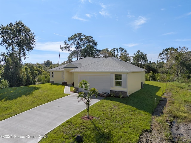 view of front of house featuring a garage and a front lawn