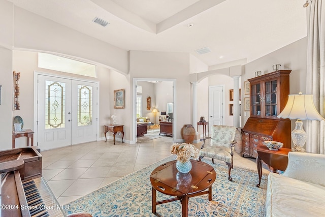 living room with french doors, light tile patterned floors, and ornate columns