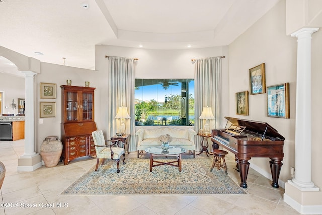 sitting room featuring ornate columns and light tile patterned floors