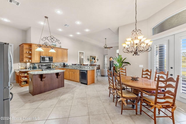 kitchen featuring a breakfast bar, a center island, decorative light fixtures, and appliances with stainless steel finishes