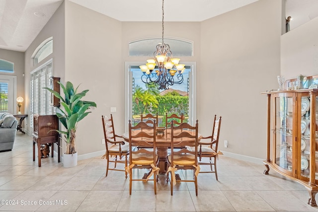 dining area featuring light tile patterned floors and a notable chandelier