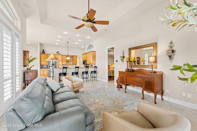 tiled living room with ceiling fan