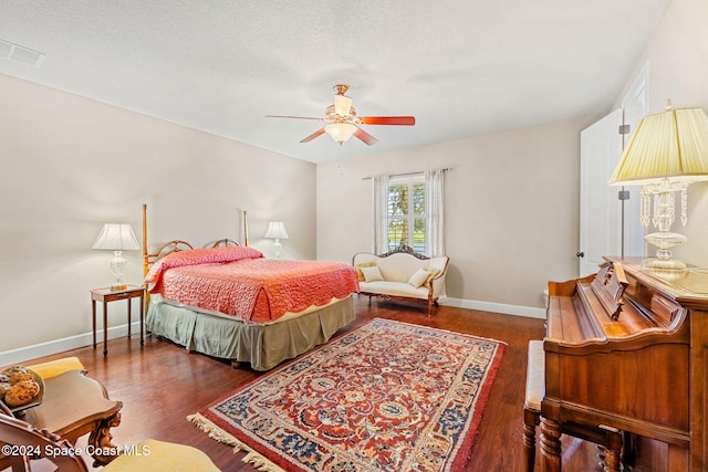 bedroom featuring ceiling fan, dark hardwood / wood-style flooring, and a textured ceiling