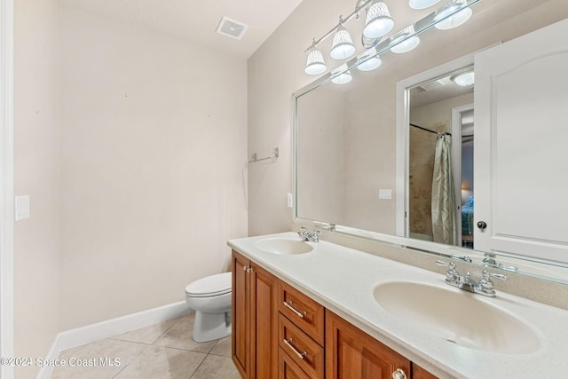 bathroom featuring tile patterned flooring, vanity, and toilet