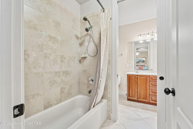 full bathroom with shower / bath combo, tile patterned floors, a textured ceiling, toilet, and vanity