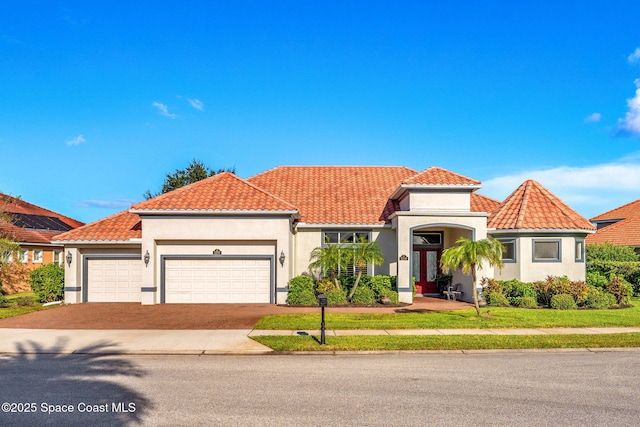 mediterranean / spanish house featuring french doors and a garage