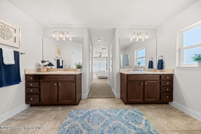 bathroom with a textured ceiling and vanity