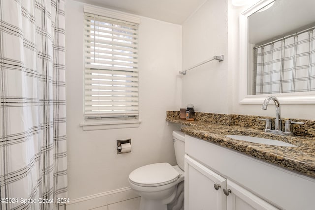 bathroom with vanity, toilet, and tile patterned floors