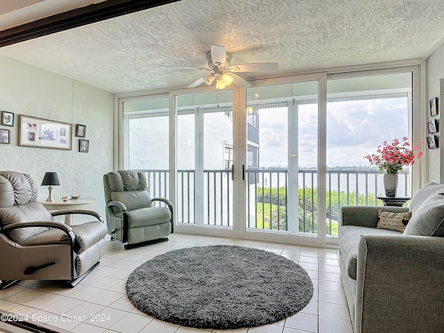 sunroom featuring ceiling fan