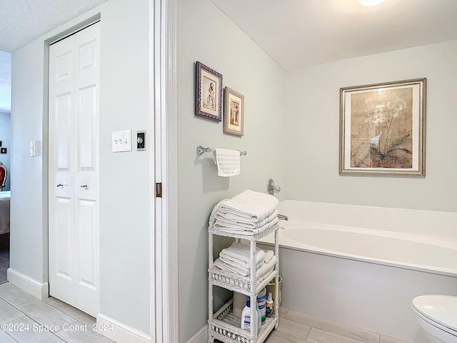 bathroom featuring a bathtub and toilet