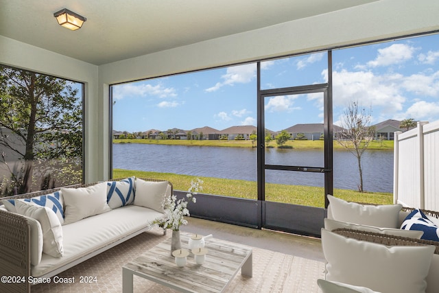 sunroom / solarium featuring a healthy amount of sunlight and a water view