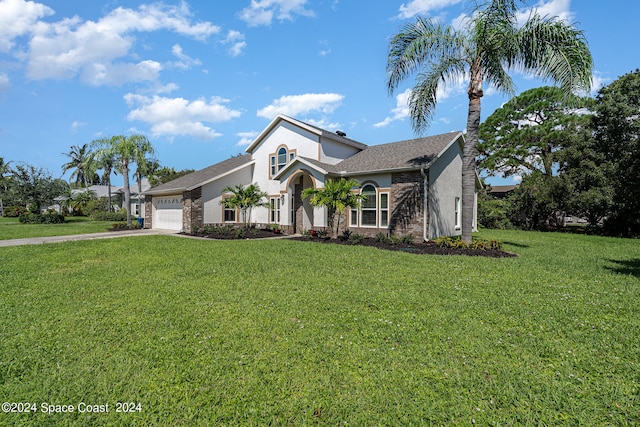 view of front of house with a garage and a front yard