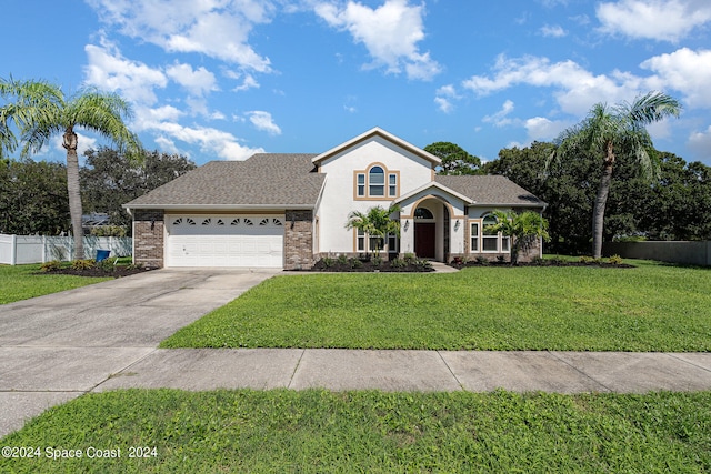 view of front of house with a garage and a front yard