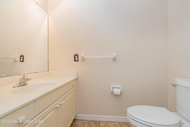 bathroom featuring tile patterned flooring, vanity, and toilet