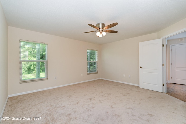 carpeted empty room with ceiling fan