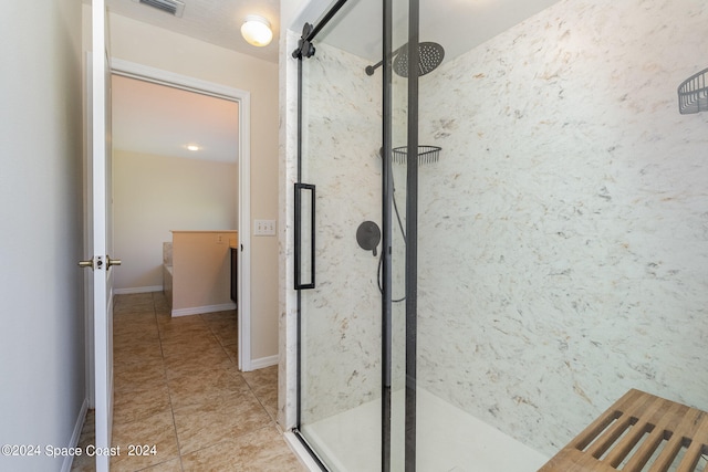 bathroom with tile patterned flooring and an enclosed shower