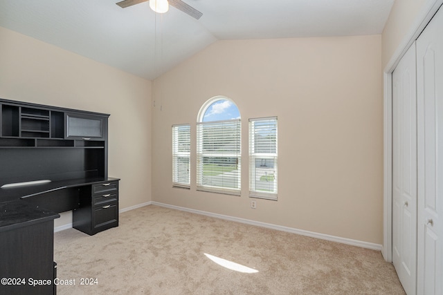 home office with lofted ceiling, ceiling fan, and light colored carpet