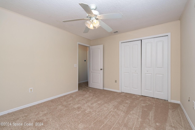 1290 Mercedes Dr, Merritt Island, FL 32952 - unfurnished bedroom featuring carpet floors, a closet, baseboards, a ceiling fan, and a textured ceiling
