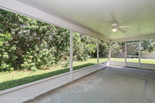 unfurnished sunroom featuring ceiling fan