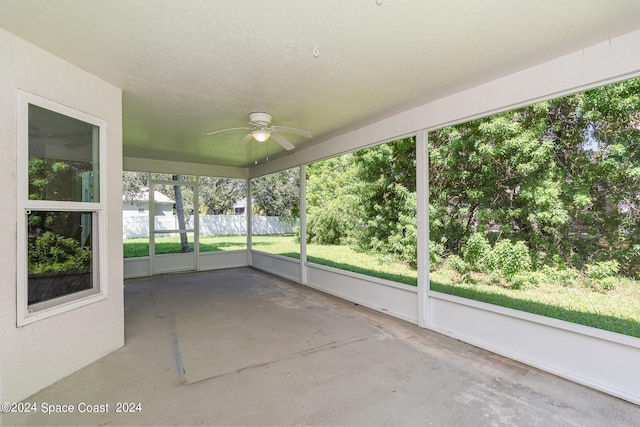 unfurnished sunroom featuring ceiling fan