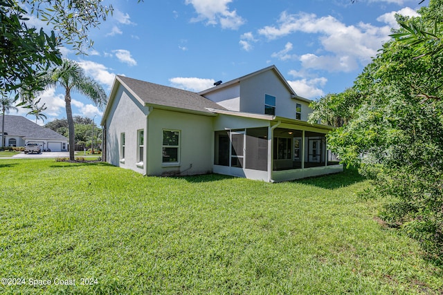 back of property with a lawn and a sunroom