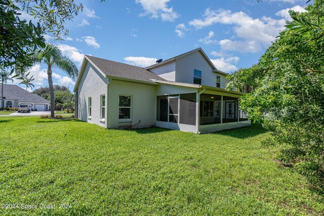 1290 Mercedes Dr, Merritt Island, FL 32952 - back of property with a sunroom, stucco siding, and a yard