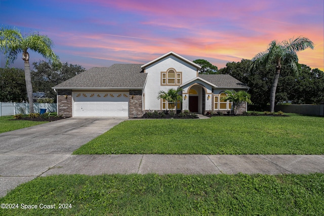 view of front of property with a lawn and a garage