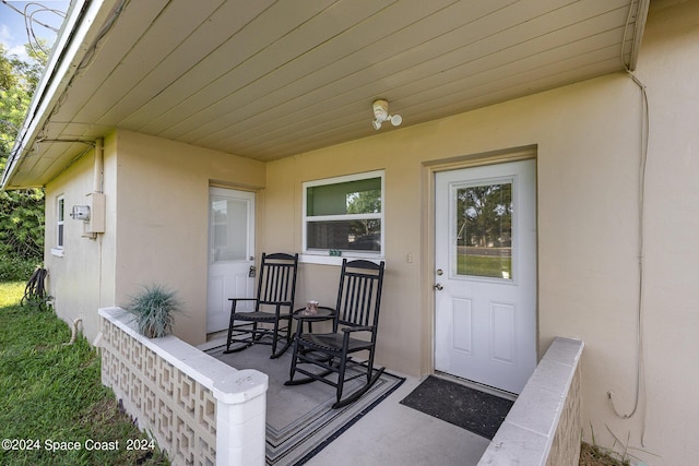 view of exterior entry with a porch