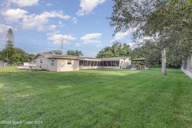 view of yard with a sunroom