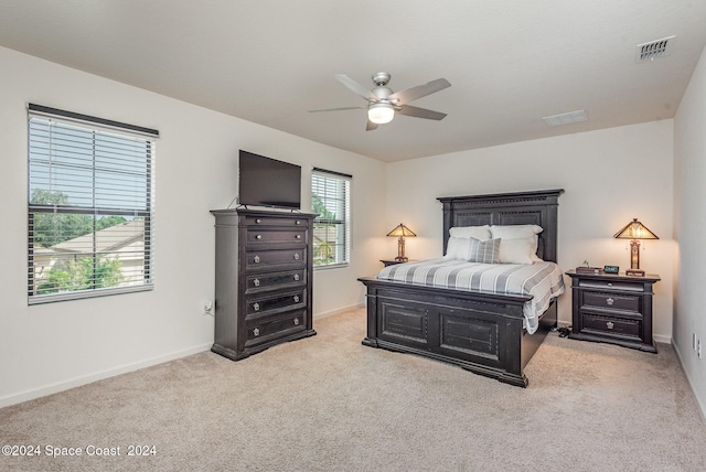 bedroom featuring light carpet and ceiling fan