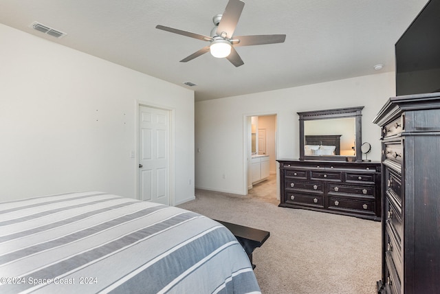 carpeted bedroom featuring ensuite bathroom and ceiling fan