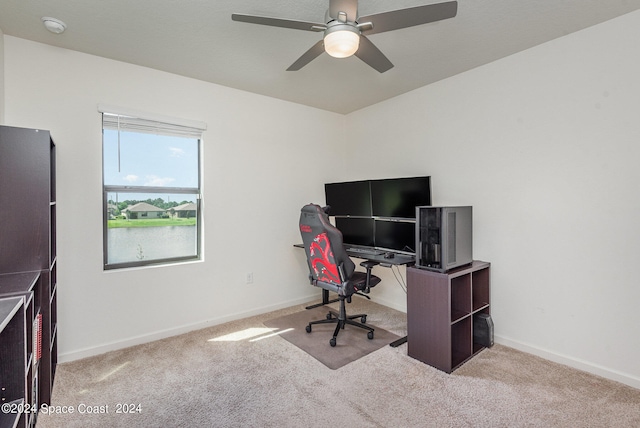 carpeted home office with ceiling fan