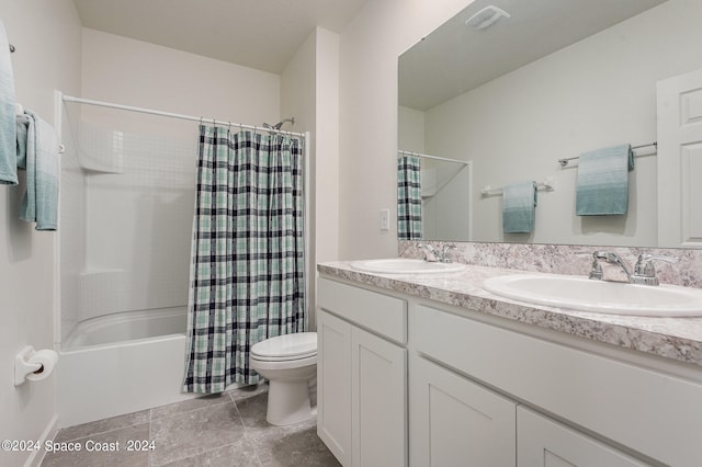 full bathroom with vanity, shower / tub combo, and toilet