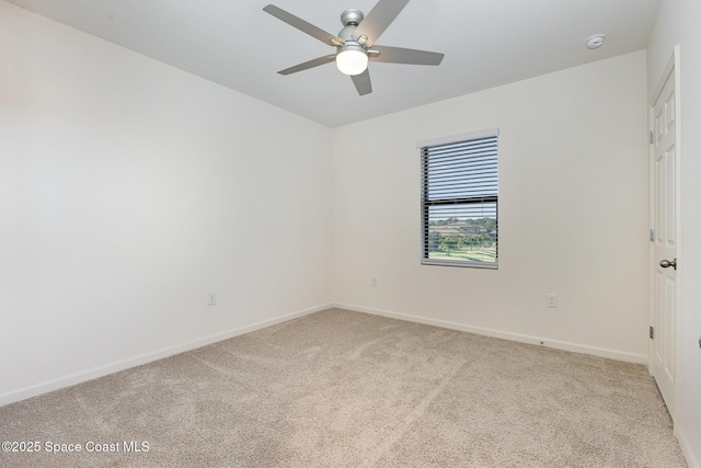 spare room with light carpet and ceiling fan