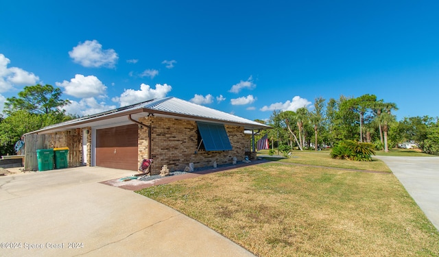 view of front of property featuring a garage and a front lawn